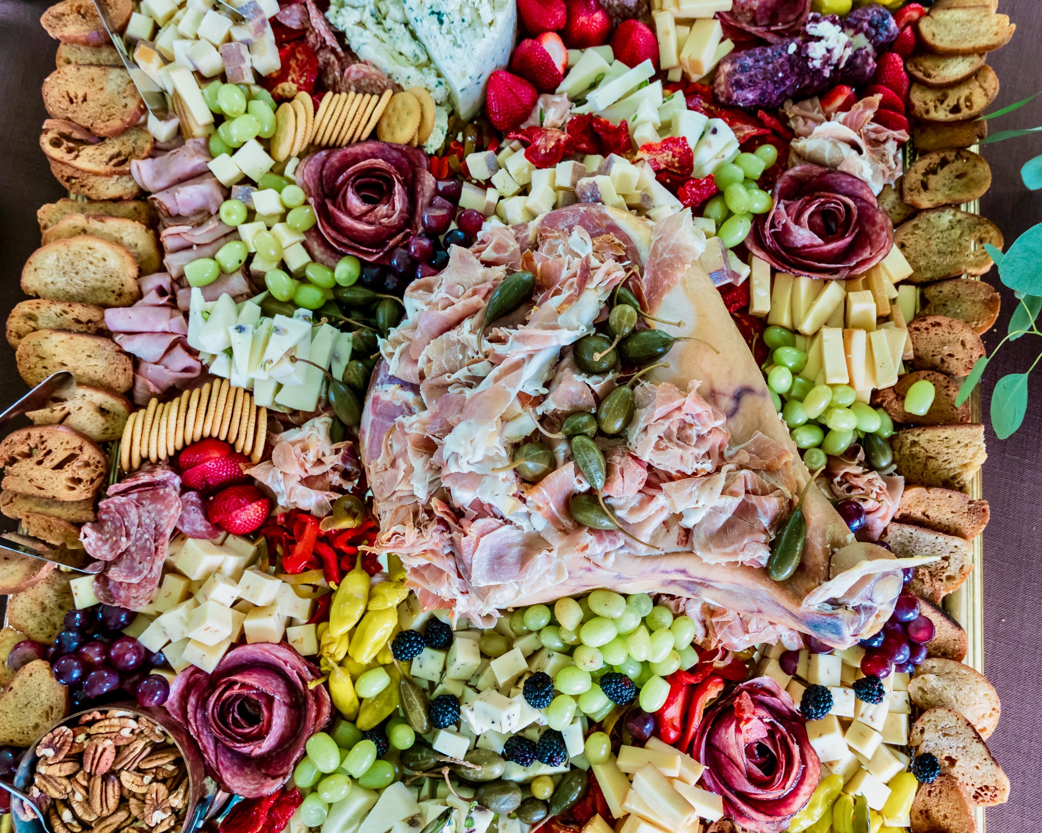 Grand grazing display with artisan cheeses, cured meats and fruit