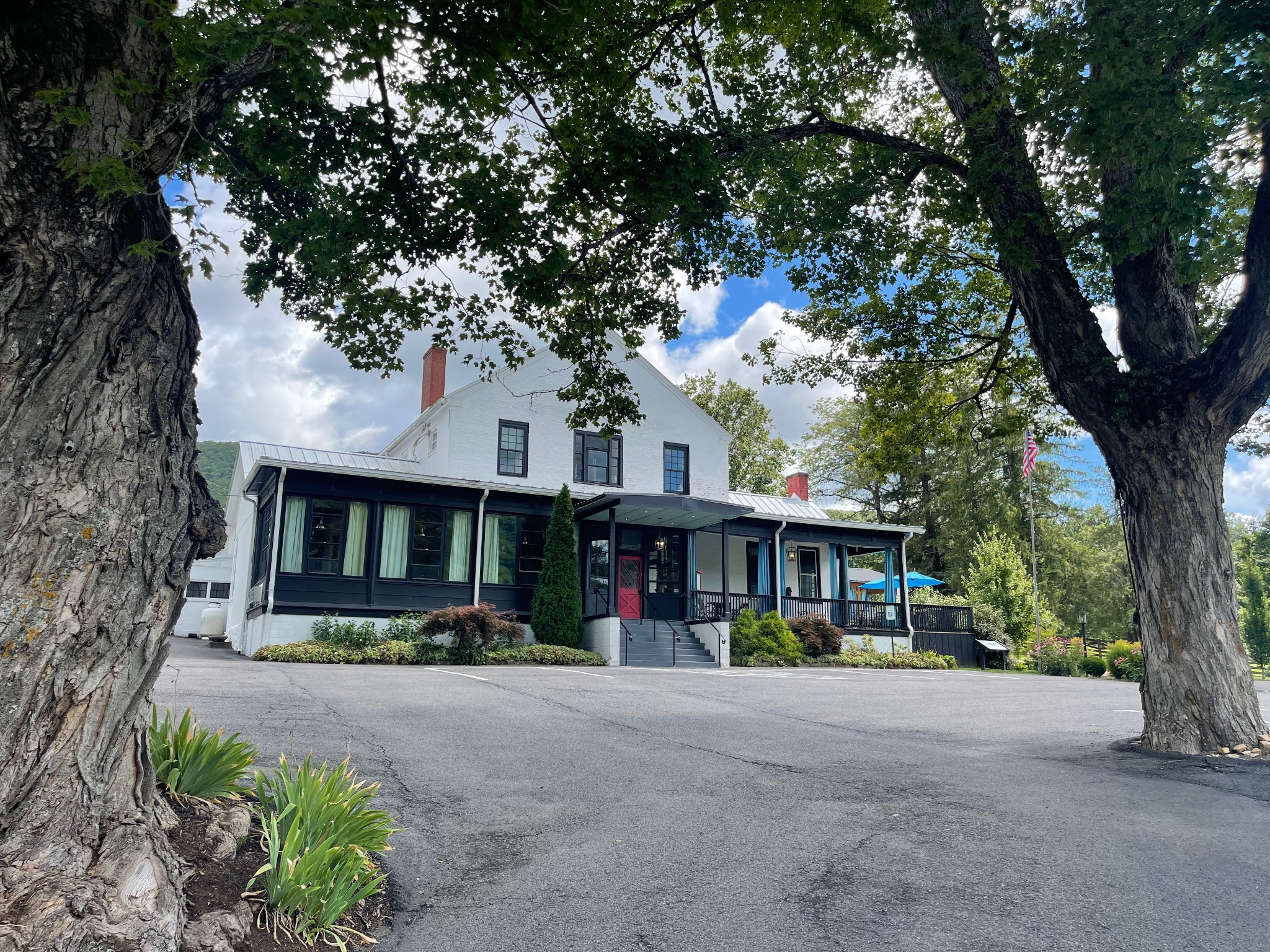 The Inn at Warm Springs framed by mature trees