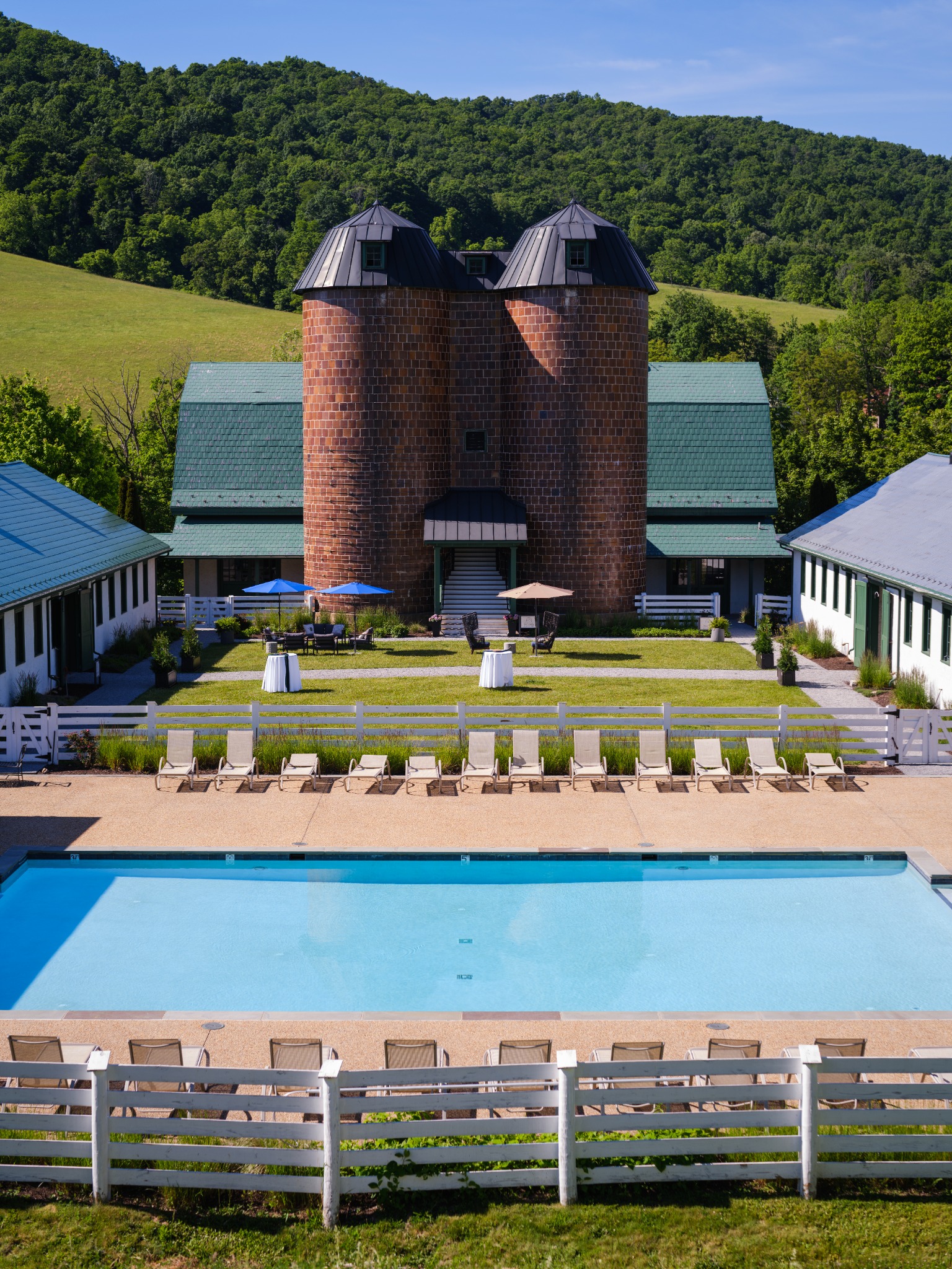 The Old Dairy silo, courtyard and pool against the mountains